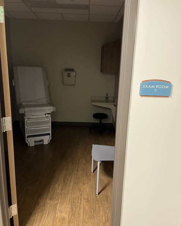 An empty exam room in the Thomasville Regional Medical Center in Alabama. The lights are off, but there's still paper on the exam chair.