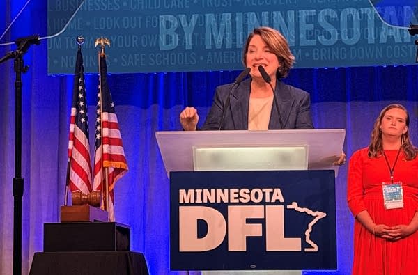 A woman speaks at a microphone