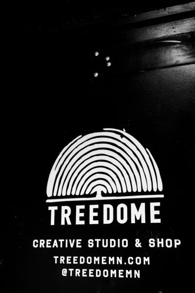 A painted logo on a door of a studio and shop