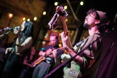 Three musicians performing onstage