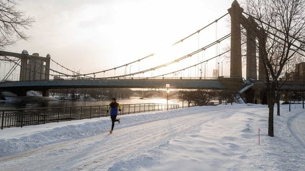 A person runs on a paved path.