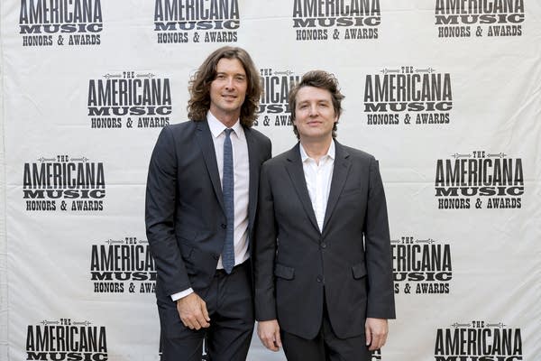 Two men stand together for a portrait at an awards event