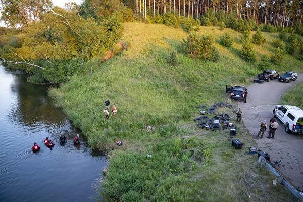 Crews search river as law enforcement looks on