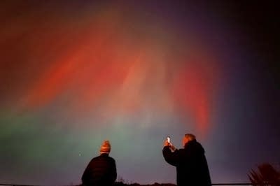 Green and red lights hang in the sky.