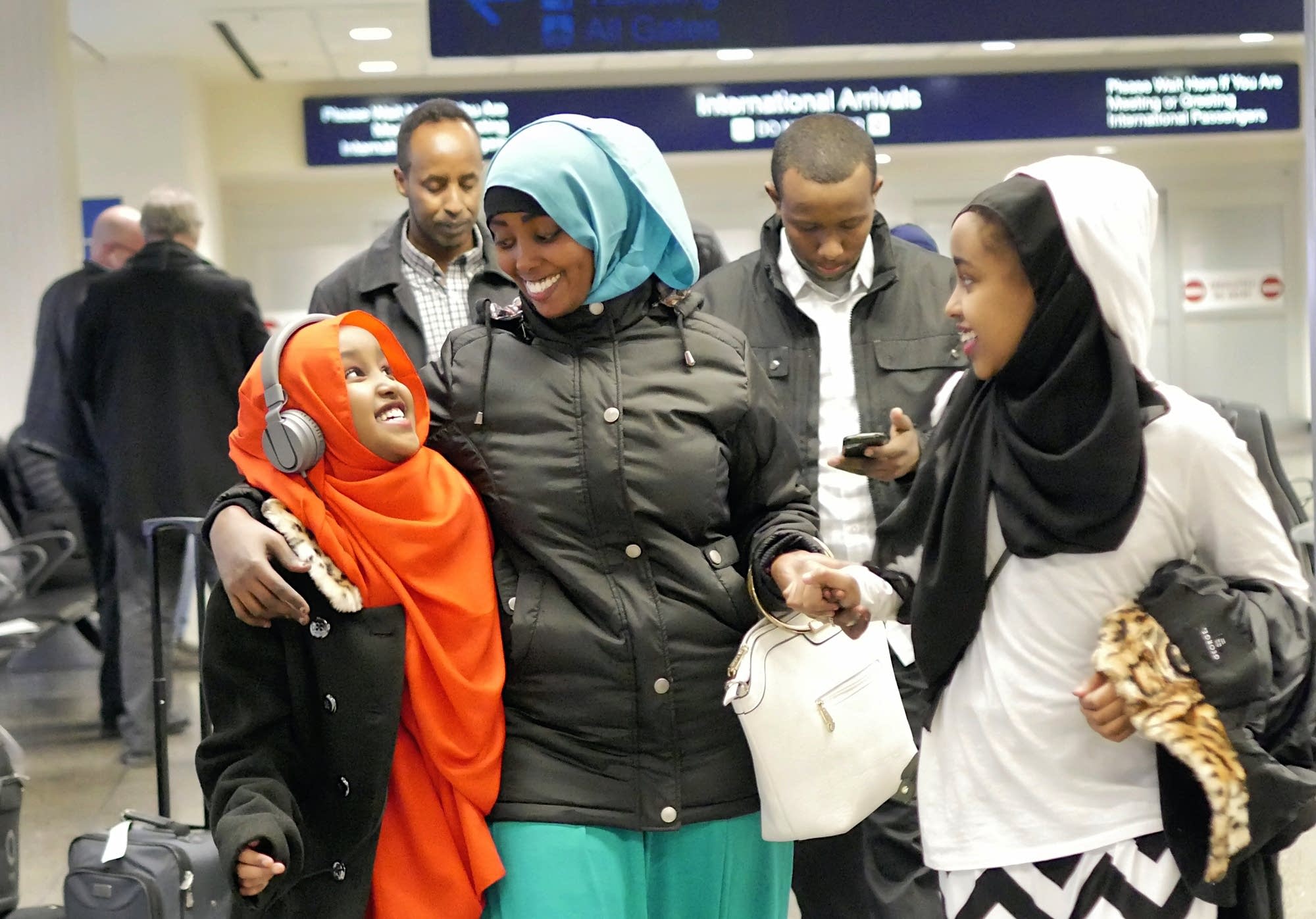 Asiya Iyow and her sister Maryama welcome their aunt, Ayan Abdi.