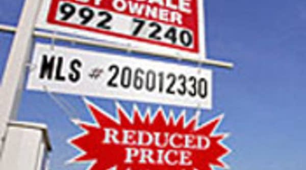 A "For Sale" sign hangs in front of a home in Naples, Fla., a city that a March 2006 survey declared the most overvalued housing market in the US.