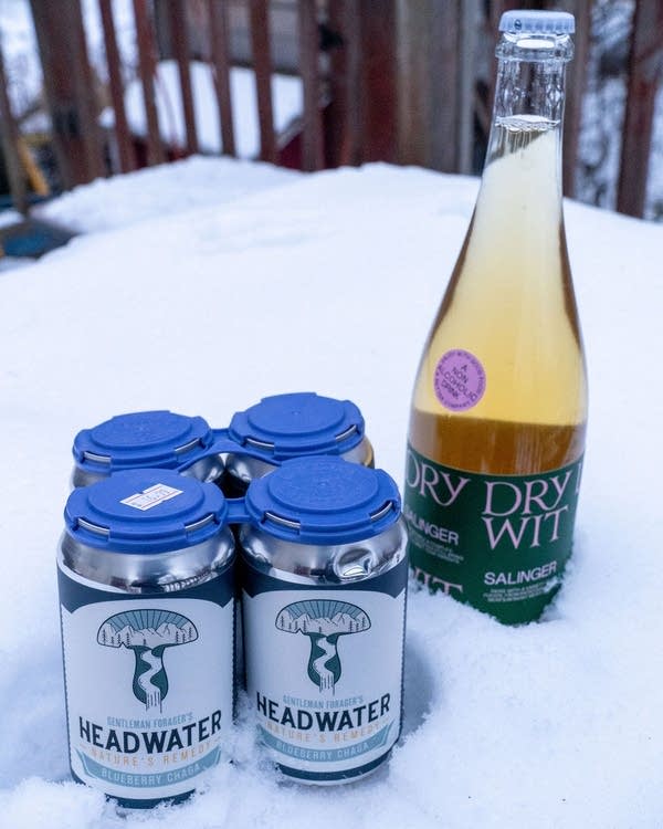 A four-pack of mushroom drink and a bottle of wine.