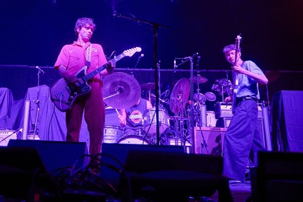 Three musicians performing onstage