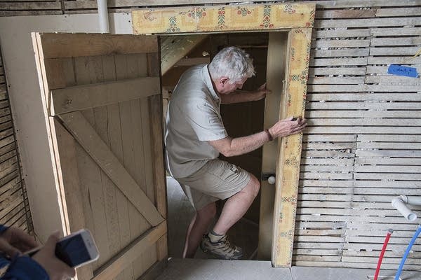 A man walks through a doorway. 