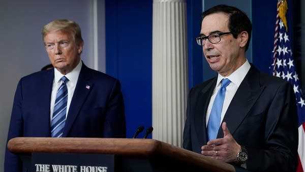 Treasury Secretary Steven Mnuchin speaks as President Donald Trump looks on during a press conference. The Treasury Department Friday released guidance on the payroll tax deferral.