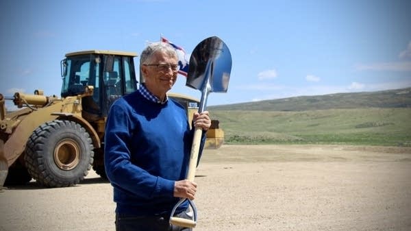 Bill Gates stands with a groundbreaking shovel at the TerraPower event last year.