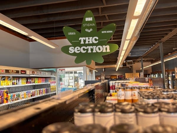 A hemp leaf-shaped sign reads "THC Section" in a store.