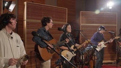 Four musicians performing in a recording studio