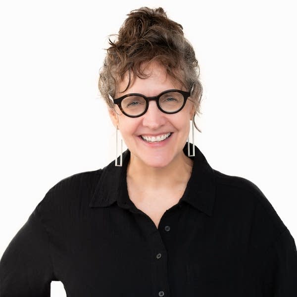 A woman smiles for a portrait