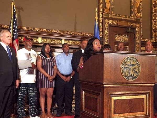 Valerie Castile speaks, accompanied by family members and Gov. Dayton