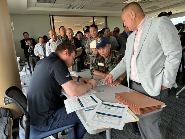 People line up at a table