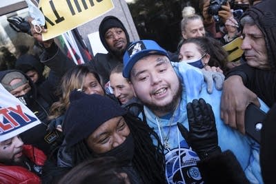 people celebrate a guilty verdict outside a courthouse