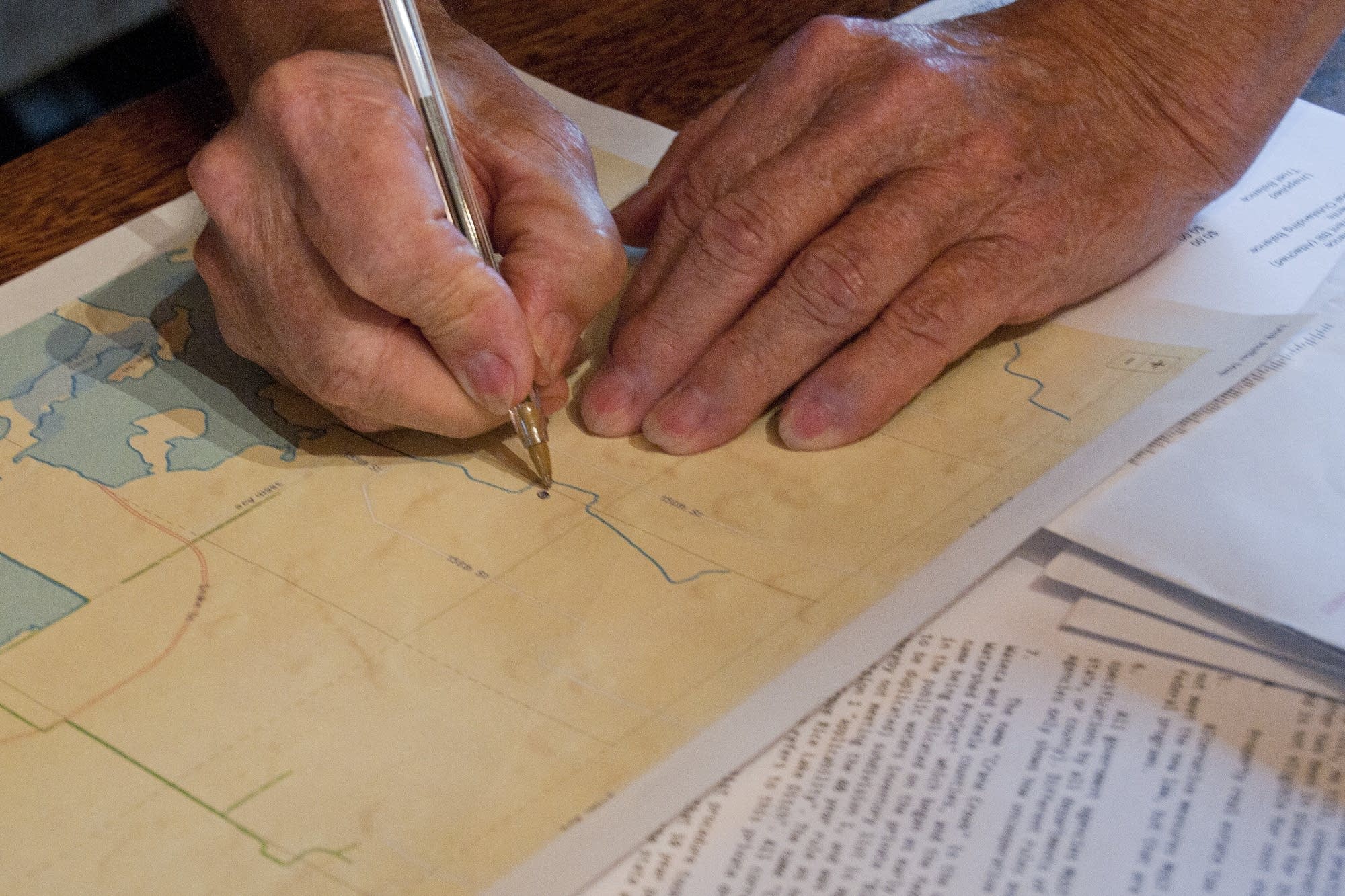 Rollie Norton marks his property on a map