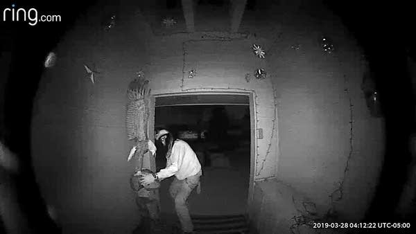 A man tries to leave with an bald eagle carving.