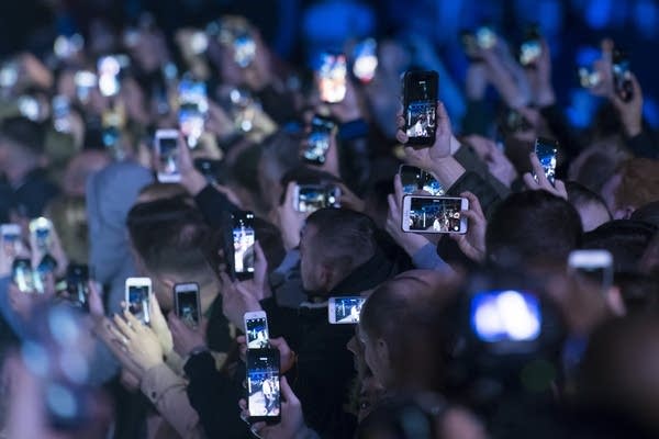 Spectators hold up their smartphones at an event in Cardiff, United Kingdom. (Photo by Matthew Horwood/Getty Images)