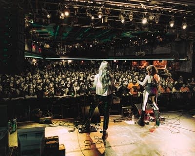 A rock band performing onstage in a music venue