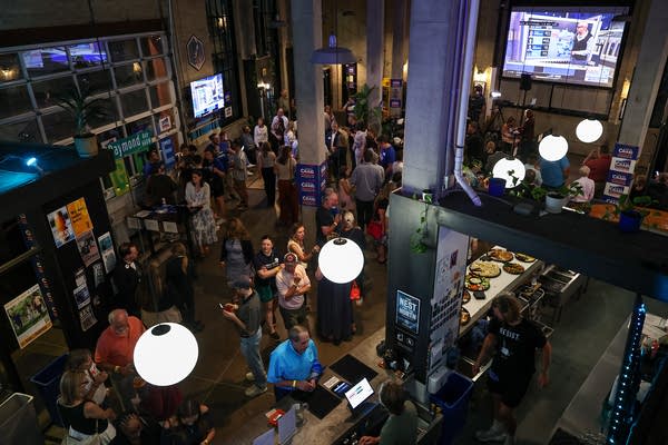 Overhead shot of a crowded brewery for an election watch party.