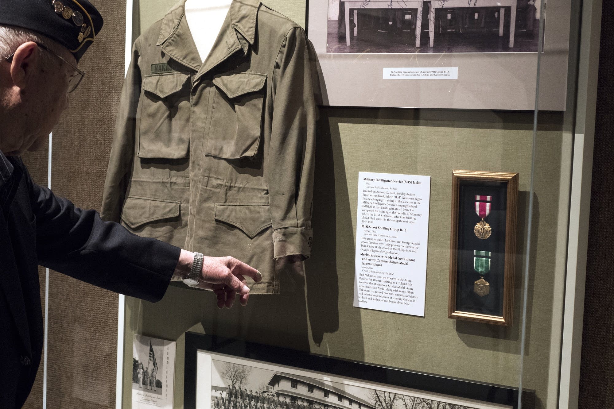 Bud Nakasone of St. Paul points out his jacket and medals in the display.