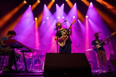 A band performing in a large music venue