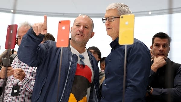 CUPERTINO, CA - SEPTEMBER 12: Apple chief design officer Jony Ive (L) and Apple CEO Tim Cook inspect the new iPhone XR during an Apple special event at the Steve Jobs Theatre on September 12, 2018 in Cupertino, California. Apple released three new versions of the iPhone and an update Apple Watch.