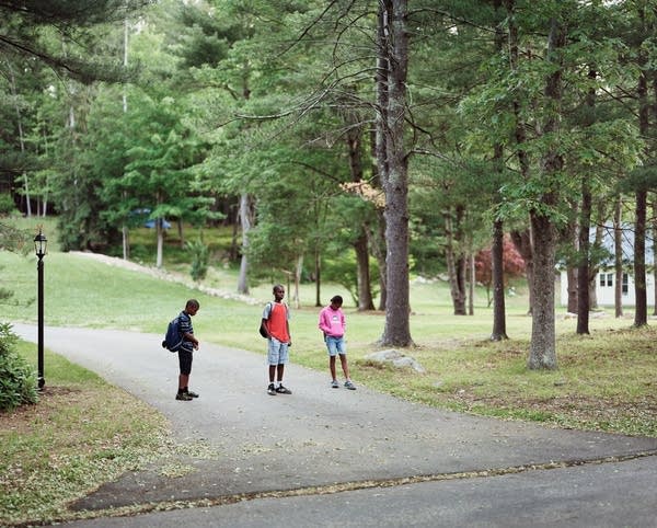 Children wait for their morning bus to school. 