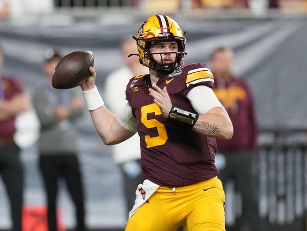A football quarterback throws the ball