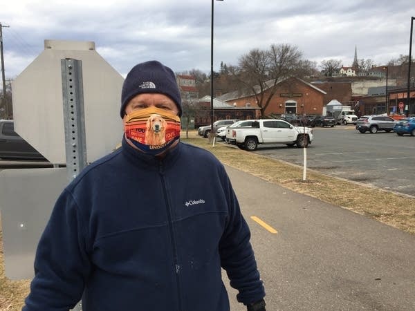 A person poses for a photo outside.