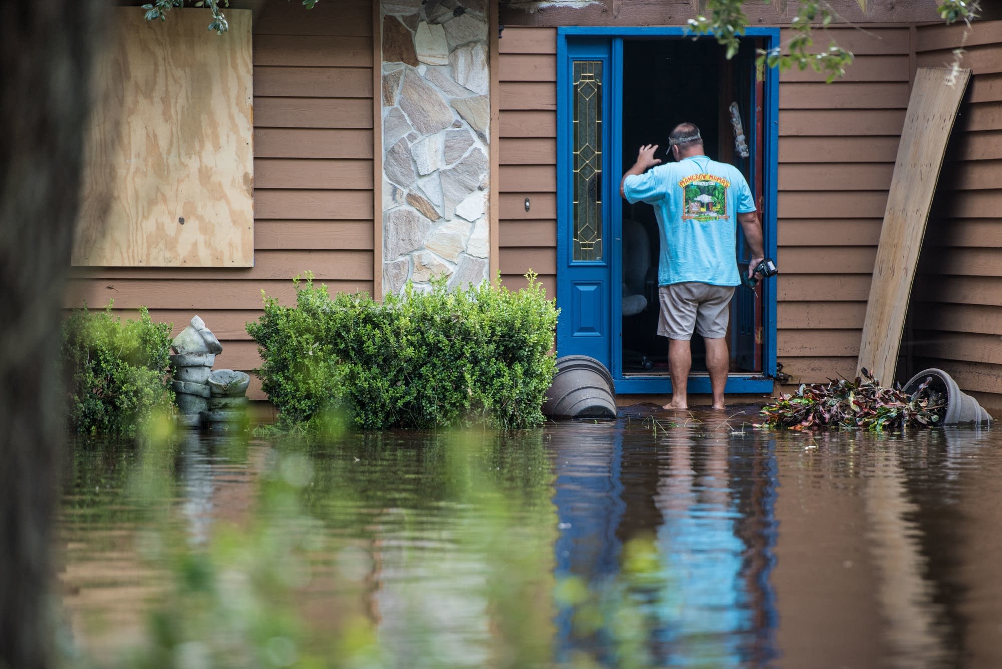 Obie Lands begins cleanup at his home.