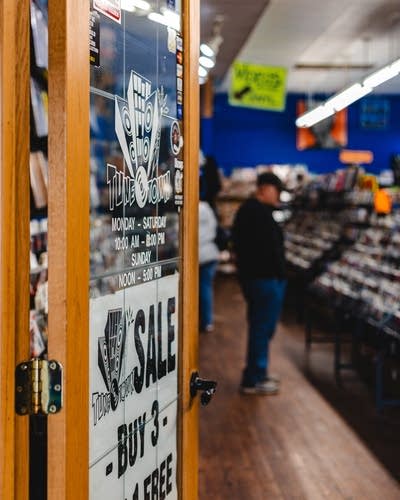 People looking at records and CDs in a record store