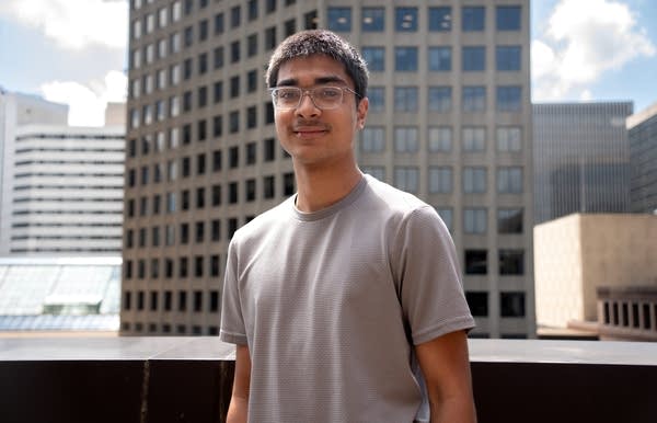 a young man poses for a portrait