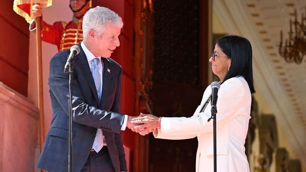 Venezuela's interim President Delcy Rodriguez and U.S. Energy Secretary Chris Wright shake hands at a press conference after agreeing to a deal between Venezuela and Chevron — among other oil majors —  on Wednesday.