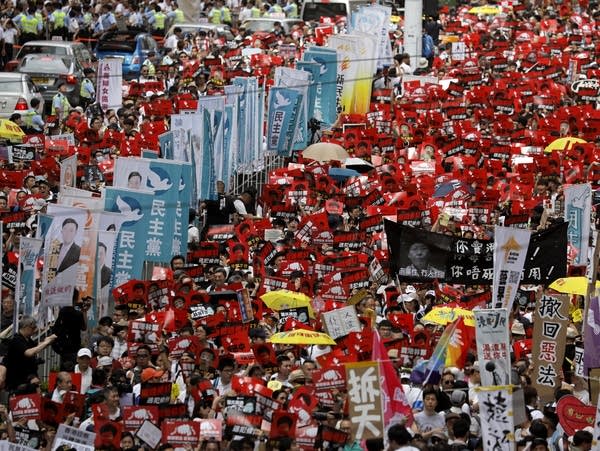 Protesters march along a downtown Hong Kong street