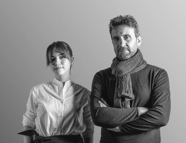 A black and white photo of a woman and a guy