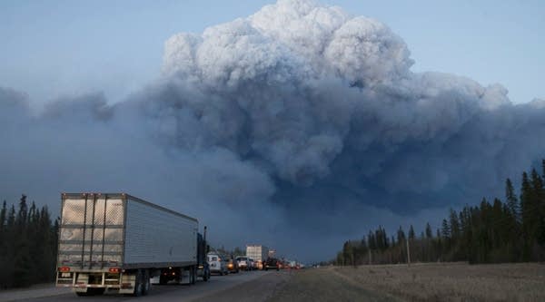  Drivers wait for clearance to take firefighting supplies into town on Thursday outside of Fort McMurray, Alberta. 