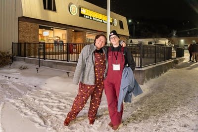 Two people posing in the snow
