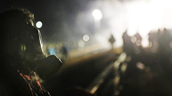 Protesters stand on the bridge leading to the DAPL Pipeline site.