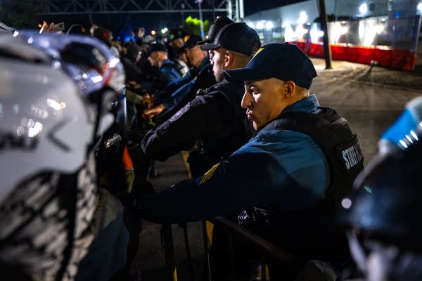 Law enforcement officers clash with anti-ICE protesters outside Delaney Hall