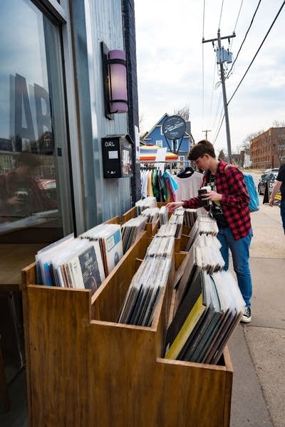 Person looking through records outdoors