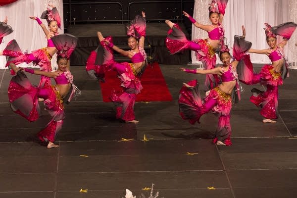 A dance group performs on stage.