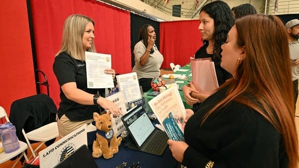 Job seekers speak with prospective employers during a career fair in Los Angeles.