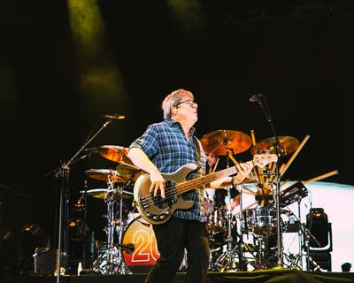 bassist of the band matchbox twenty performing at an outdoor music festival at night
