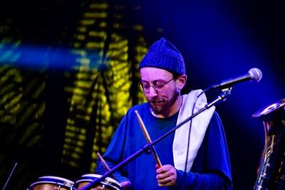 A musician plays drums onstage