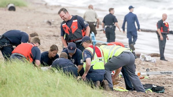 Emergency personnell administer CPR to a girl pulled from Lake Superior