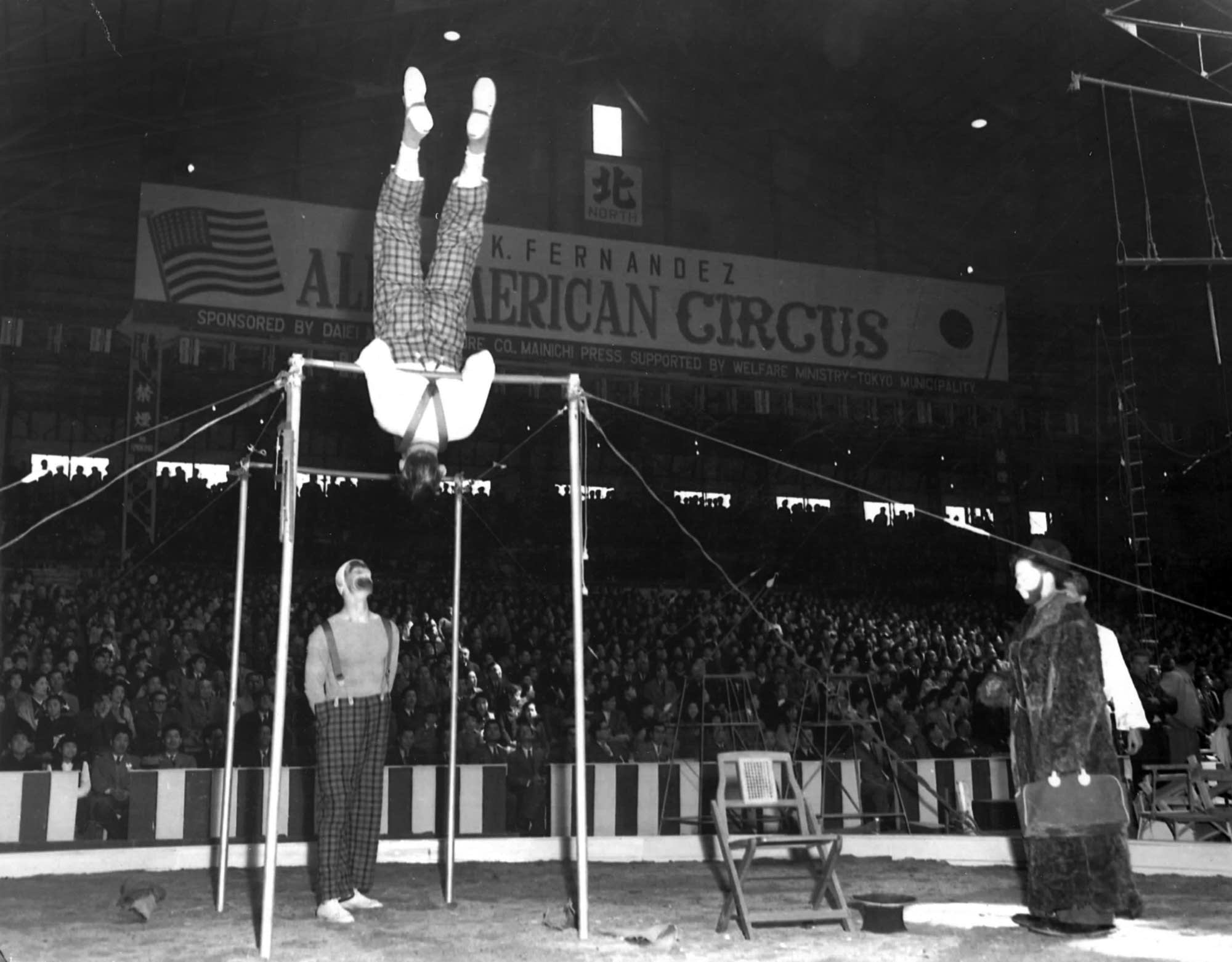 Dudley Riggs, spotting his father on the bars,