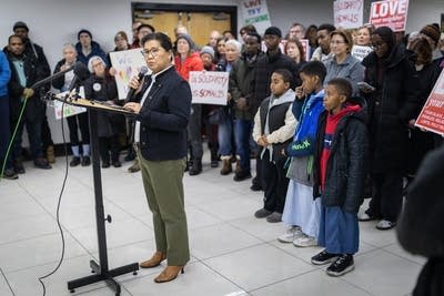 A woman speaks at a press conference